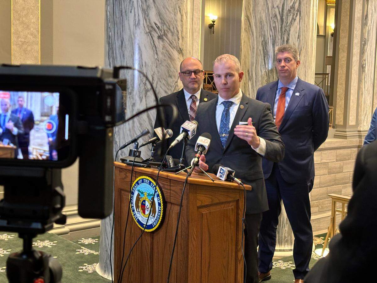 Sen. Rick Brattin, center, speaks to reporters. He’s joined by Sen. Denny Hoskins, left, and Sen. Bill Eigel, right.