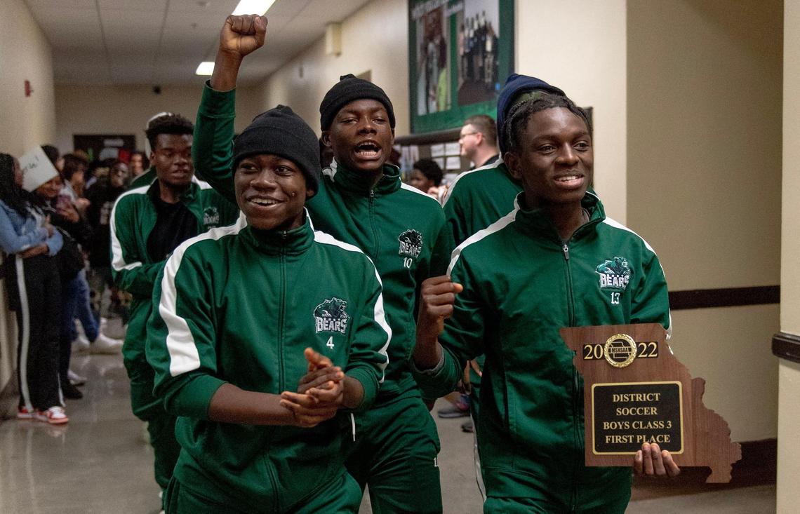 East High School soccer players Omari Shabani, left, Esube Byoke and Msafiri Ebunga walk through the halls at East High School during a pep rally before the state tournament on Thursday, Nov. 17, 2022 in Kansas City.