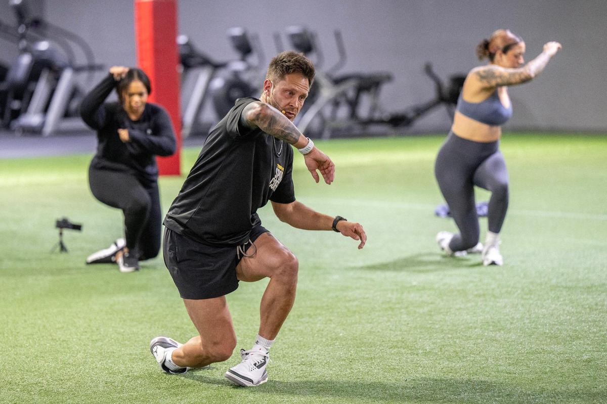 Stroupe leads participants through a mobility exercise during the Friday workout in Olathe.