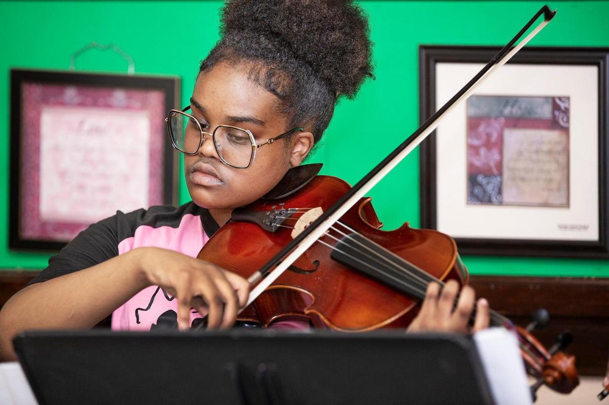 Kezia Rono, 13, kept her eye on the music during a strings practice session for the A-Flat Youth Orchestra Saturday, May 31, at Jamison Memorial Temple CME Church in Kansas City.