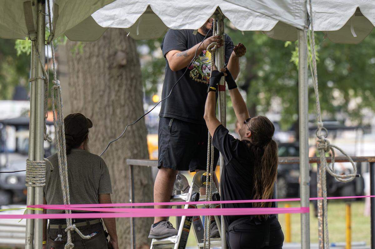 Event staffers set up tent lights outside the National WWI Museum and Memorial on Tuesday, Sept. 30, 2025, in Kansas City, ahead of pop singer Chappell Roan's concert Visions of Damsels and Other Dangerous Things.
