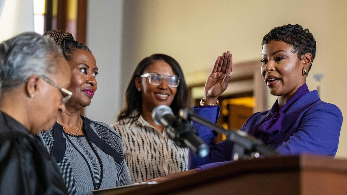 Melesa Johnson is sworn in as Jackson County Prosecutor by Presiding Judge Lisa White Hardwick of the Missouri Court of Appeals, Western District, as her mother, Melina Johnson, left, and her sister, Stacey Johnson, stand by her side on Friday, Jan. 3, in the Historic Brady Courtroom at the Truman Courthouse in Independence.