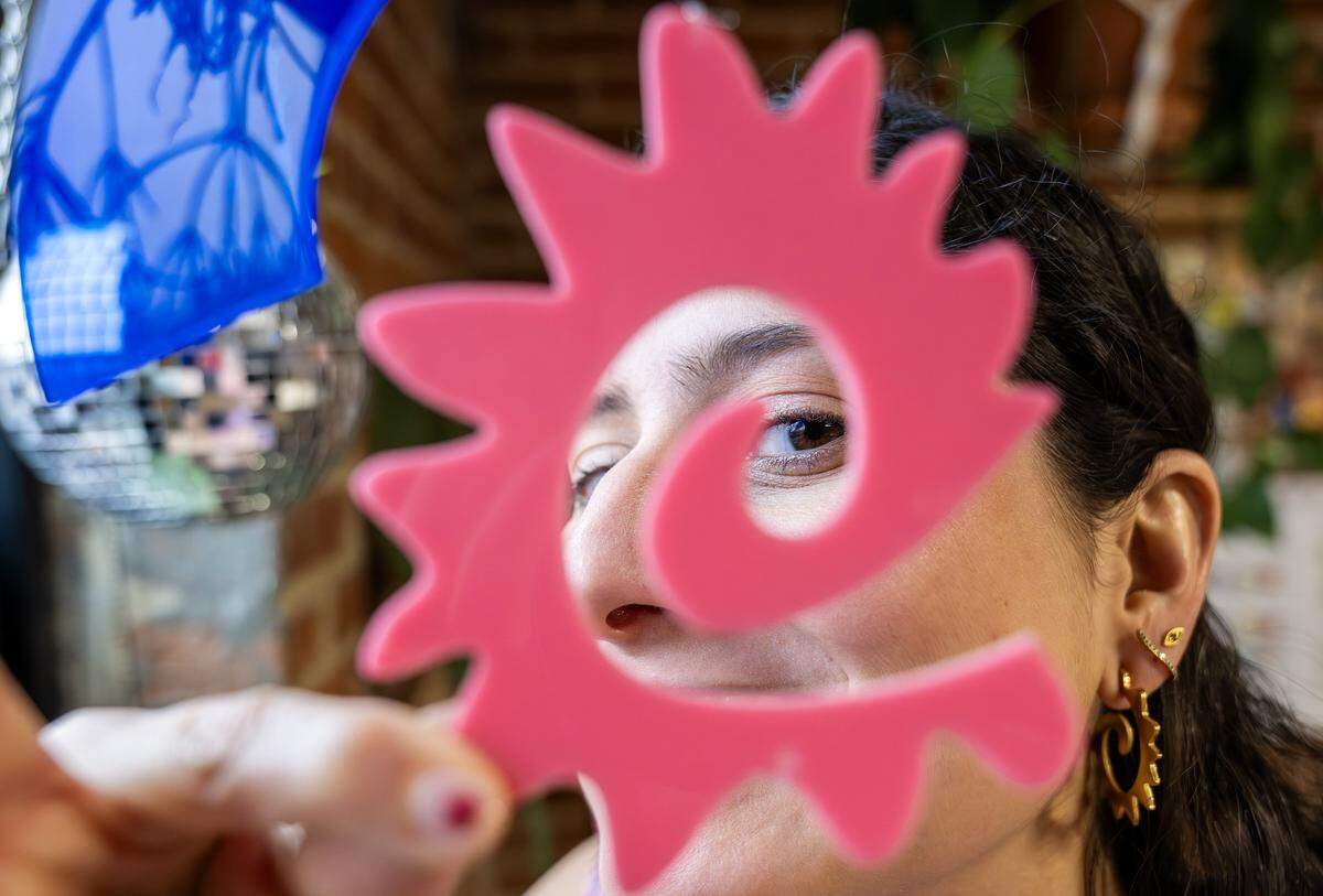 Paulina Otero holds a caracol design while posting for a portrait at her studio on Tuesday, March 3, 2026, in Kansas City.