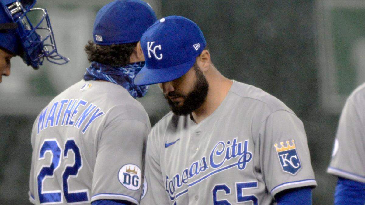 Kansas City Royals manager Mike Matheny, left, removes starting pitcher Jakob Junis from the team’s baseball game against the Detroit Tigers during the third inning Tuesday, Sept. 15, 2020, in Detroit. (AP Photo/Jose Juarez)