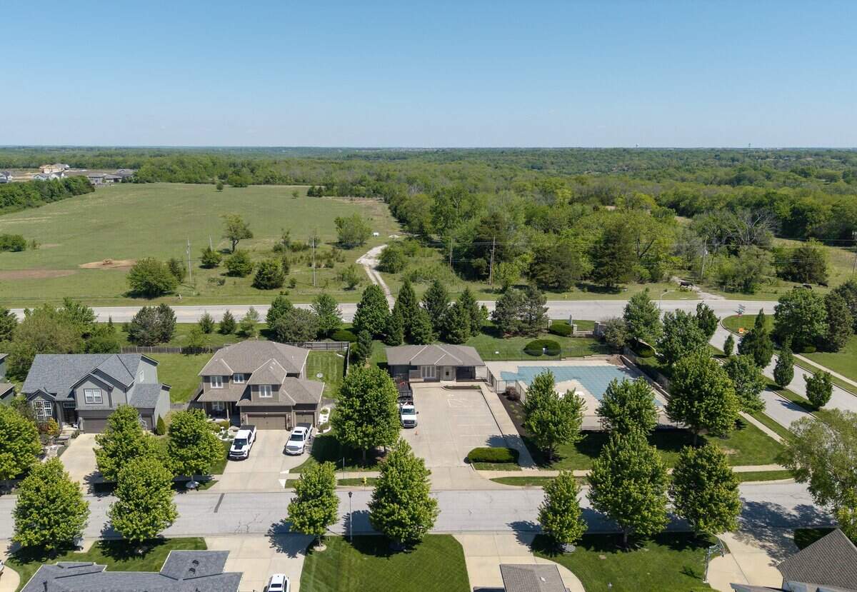 The land (top) on the north side of 143rd Street, between Cedar Niles Road and St. Andrews Avenue in Olathe, is seen on Friday, May 1, 2026. The property is the subject of a lawsuit that alleges the city is forcing eminent domain for a private real estate developer's project. This view is shows property owned by the Olathe School District, just north of St. Andrews Avenue and the homes in the The Greens of Prairie Highlands subdivision.