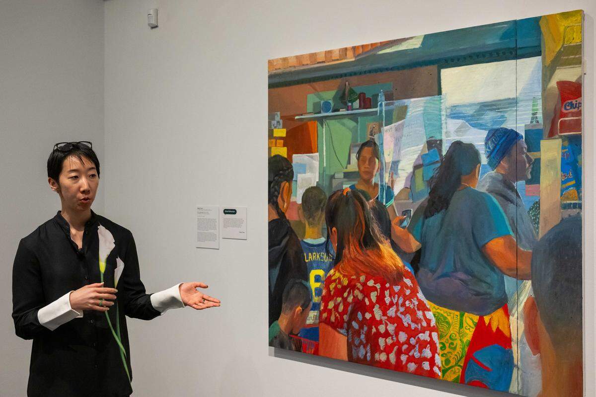 Chief Curator Jessica Hong speaks about work from Mikey Yates titled K.C. sari-sari,  before the opening of “The World in Kansas City,” an art exhibition showcasing work from artists' that have connections to Kansas City, on Thursday, March 5, 2026, at the Kemper Museum of Contemporary Art.