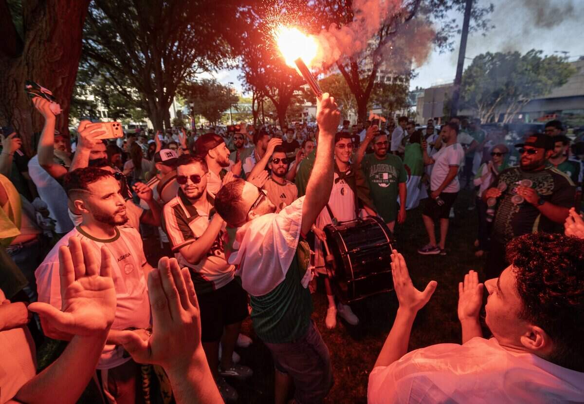 Algerian fans rally at Washington Park near Union Station the night before their team takes on defending World Cup champ Argentina at Kansas City Stadium.