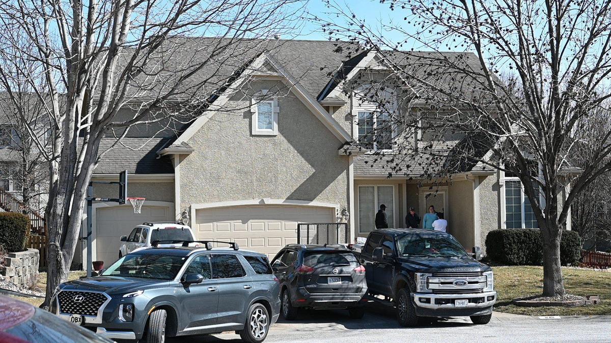 People were on the porch of a home in the 8400 block of Laurelwood Street on Monday, Feb. 28, 2022, in Lenexa where a triple shooting Sunday, Feb. 27, 2022, left three people dead. One person died at the scene and two other died after being transported to a hospital.