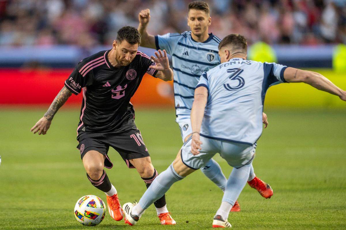 Inter Miami forward Lionel Messi (10) bypasses Sporting Kansas City defender Andreu Fontàs (3) in the first half during an MLS game at GEHA Field at Arrowhead Stadium on Saturday, April 13, 2024, in Kansas City.