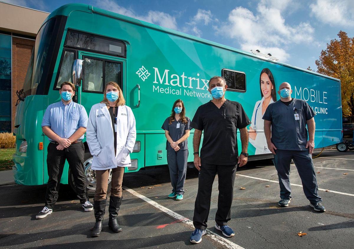 A mobile health clinic hits the road in the Kansas City area this week to sign up participants for an AstraZeneca COVID-19 vaccine trial. Researchers include, from left, Stephen Nelson and Jennifer Bedard from University of Kansas Medical Center, and Emily Hart, Farid Dada and Aaron Gitthens from Matrix Medical Network. Children’s Mercy is also participating in the study.