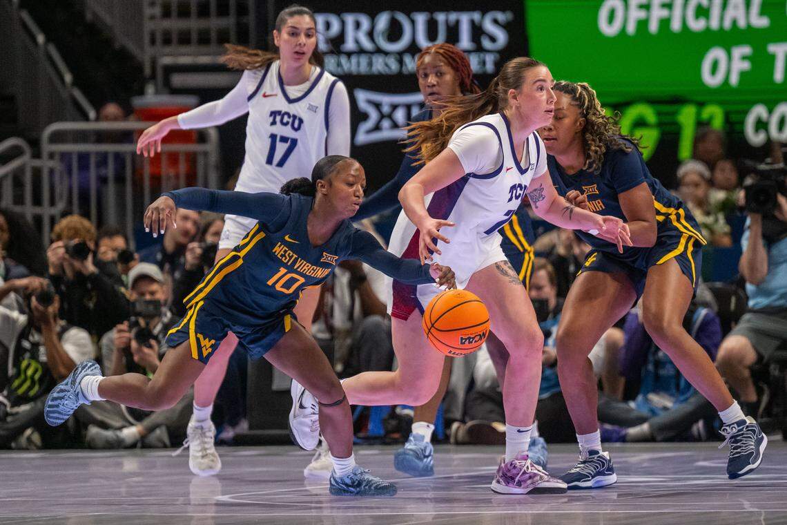 West Virginia Mountaineers guard Jordan Harrison (10) steals the ball from TCU Horned Frogs forward Marta Suarez (7) in the second half of the Big 12 Women's Basketball Tournament Final on Sunday, March 8, 2026, at T-Mobile Center. The West Virginia Mountaineers won the game 62-53.