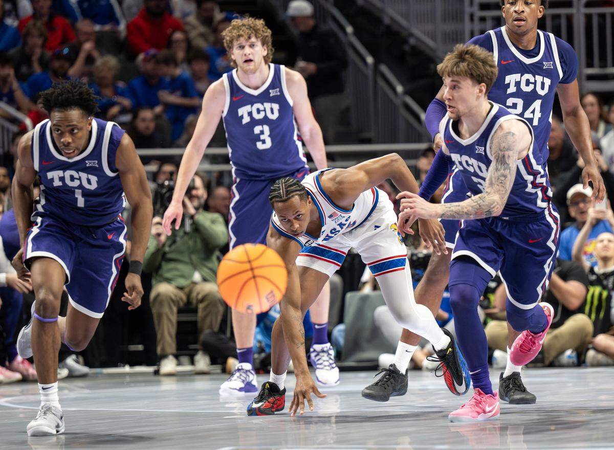 Kansas Jayhawks guard Elmarko Jackson (13) slips on the court during the first half of a Big 12 Men's Basketball Tournament game against the Texas Christian University Horned Frogs at T-Mobile Center on Thursday, March 12, 2026, in Kansas City.