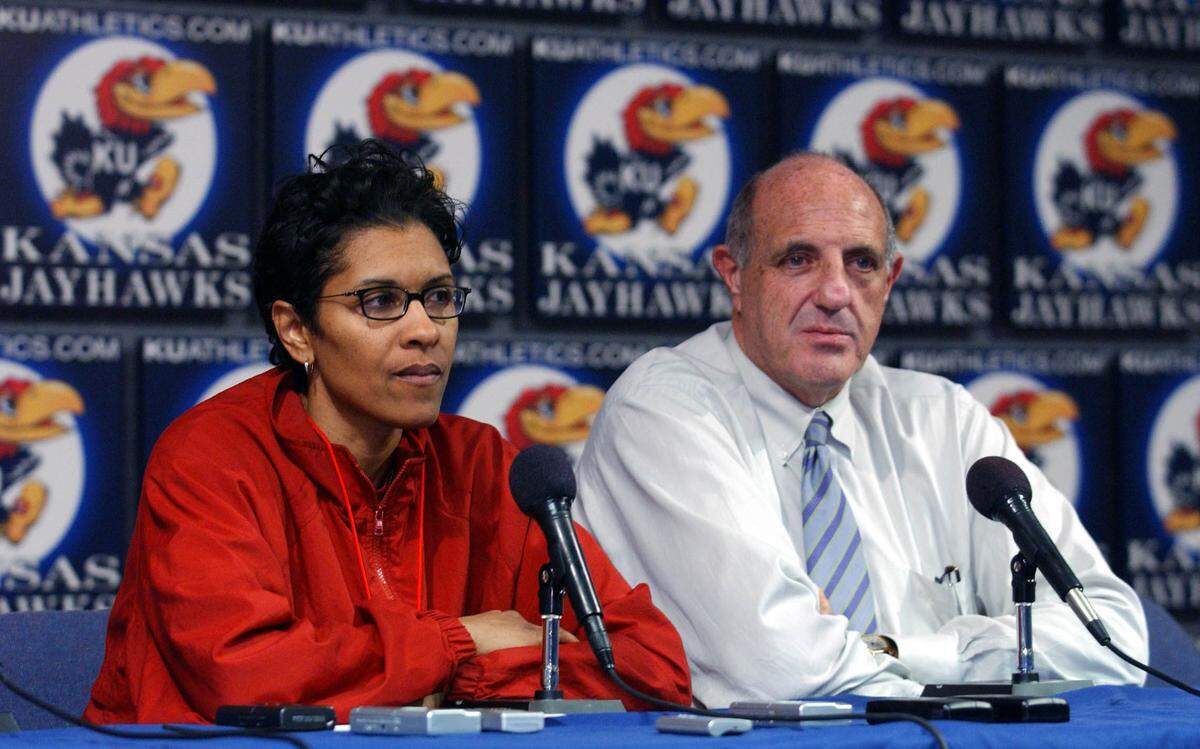Lynette Woodard, the new head coach of the University of Kansas women’s basketball team, talks to the media with Athletic Director Lew Perkins during a 2004 press conference. Woodard took over for Marian Washington on an interim basis after Washington asked for a medical leave of absence.