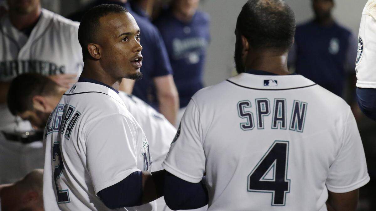 Seattle Mariners’ Jean Segura, left, talks with Denard Span in the dugout after the seventh inning against the Baltimore Orioles  during a baseball game, Tuesday, Sept. 4, 2018, in Seattle. (AP Photo/John Froschauer)                             