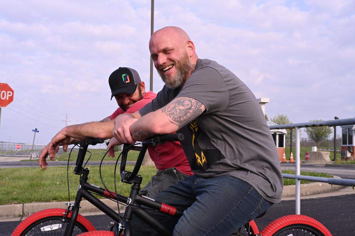 Michael Politte and his childhood friend Mike Glore ride bikes after Politte was paroled April 22, 2022, in a murder he maintains he did not commit.