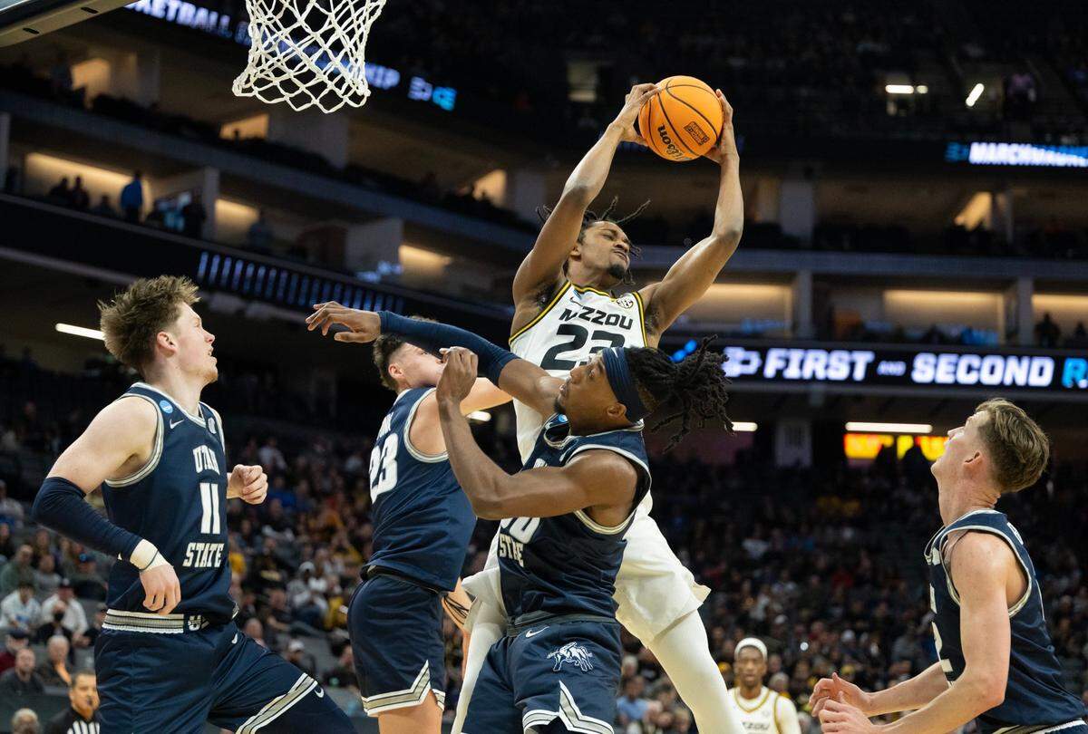Missouri Tigers forward Aidan Shaw (23) grabs rebound over Utah State Aggies forward Taylor Funk (23) and Utah State Aggies forward Dan Akin (30) during a game for the NCAA Tournament at Golden 1 Center in Sacramento, Thursday, March 16, 2023.