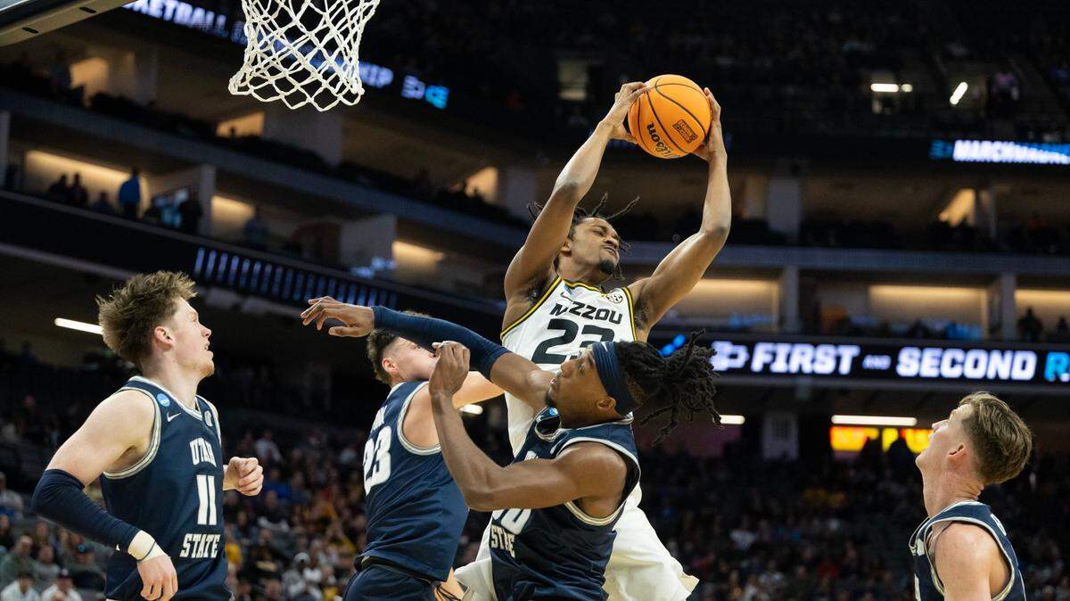 Missouri Tigers forward Aidan Shaw (23) grabs rebound over Utah State Aggies forward Taylor Funk (23) and Utah State Aggies forward Dan Akin (30) during a game for the NCAA Tournament at Golden 1 Center in Sacramento, Thursday, March 16, 2023.