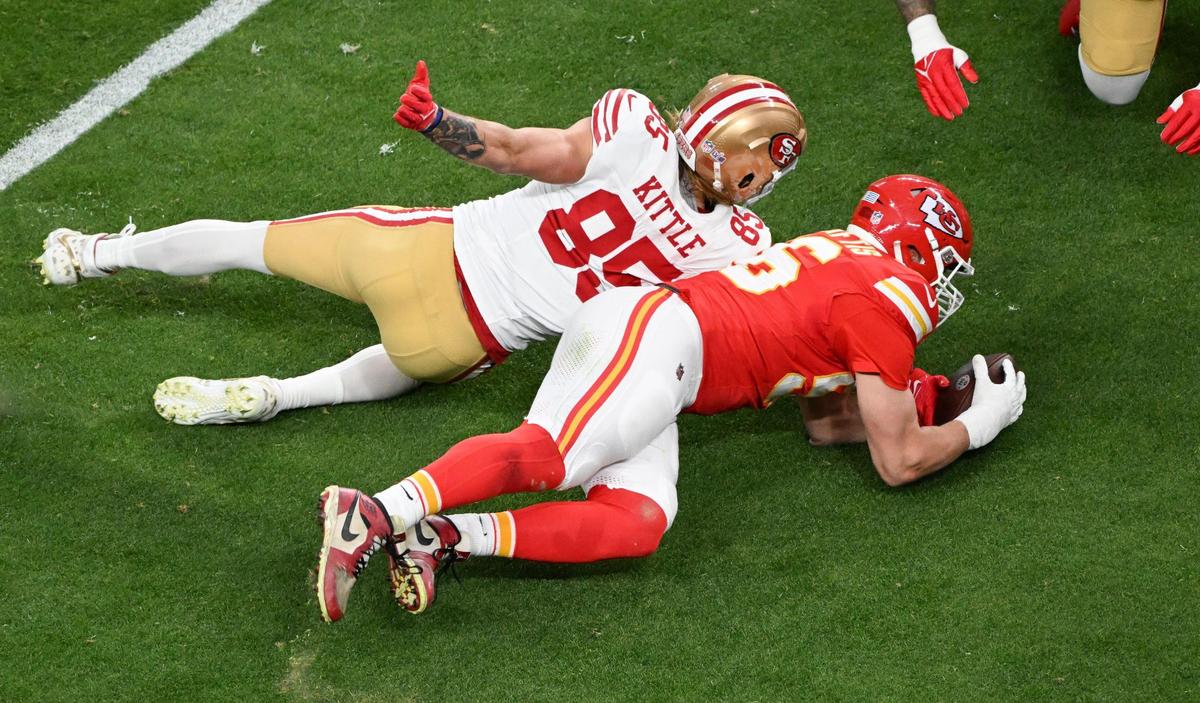 Kansas City Chiefs defensive end George Karlaftis (56) battles San Francisco 49ers tight end George Kittle (85) for a fumble by San Francisco 49ers in the first quarter Super Bowl LVIII, Sunday, Feb. 11, 2024, in Las Vegas. The Kansas City Chiefs recovered the ball.