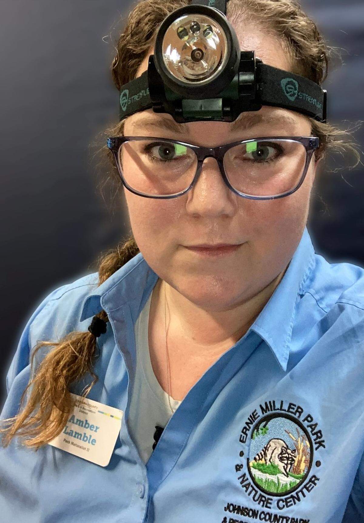 Amber Lamble, senior park naturalist at Ernie Miller Nature Center, sports a headlamp to guide her on the park’s paths after dark.