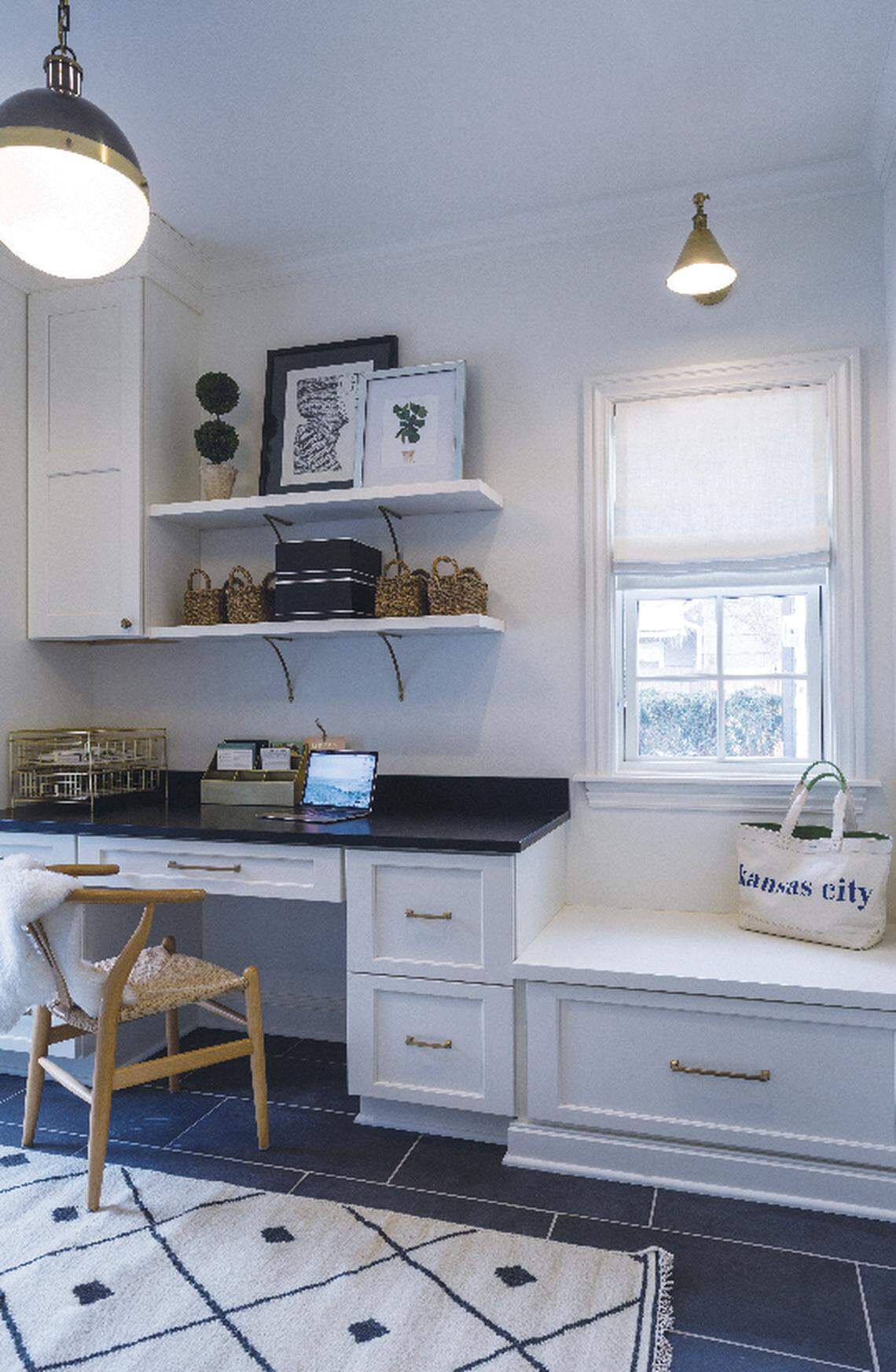 Pretty gold pulls, bright white cabinets and a built-in desk make Jen Anton’s laundry room as beautiful as it is functional.