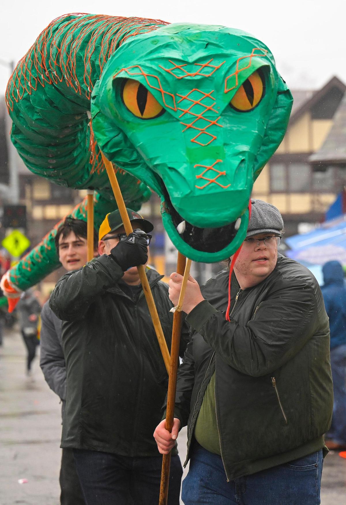 Rain didn’t dampen the festivities as an oversize snake made its’ way down the street during the 2023 Brookside St. Patrick’s Day Warm-Up Parade on Saturday March 11, 2023 in Kansas City.