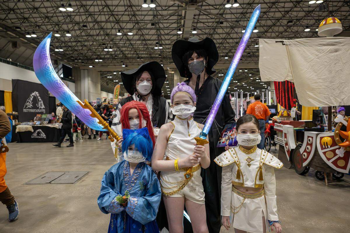 Cassandra Wheeler, left, and her husband, Josh, cosplay as characters from the movie “K-Pop Demon Hunters” during Planet Anime at the Kansas City Convention Center on Saturday, Nov. 22.