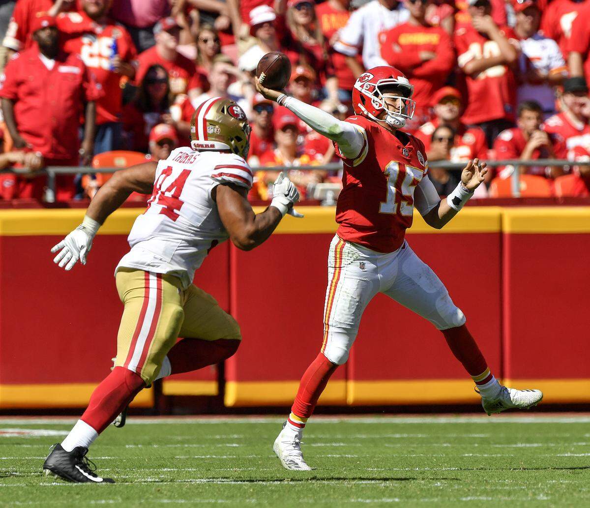 Kansas City Chiefs quarterback Patrick Mahomes throws on the run and under pressure from San Francisco 49ers defensive end Solomon Thomas in the second half during Sunday’s football game on September 23, 2018 at Arrowhead Stadium in Kansas City, Mo.