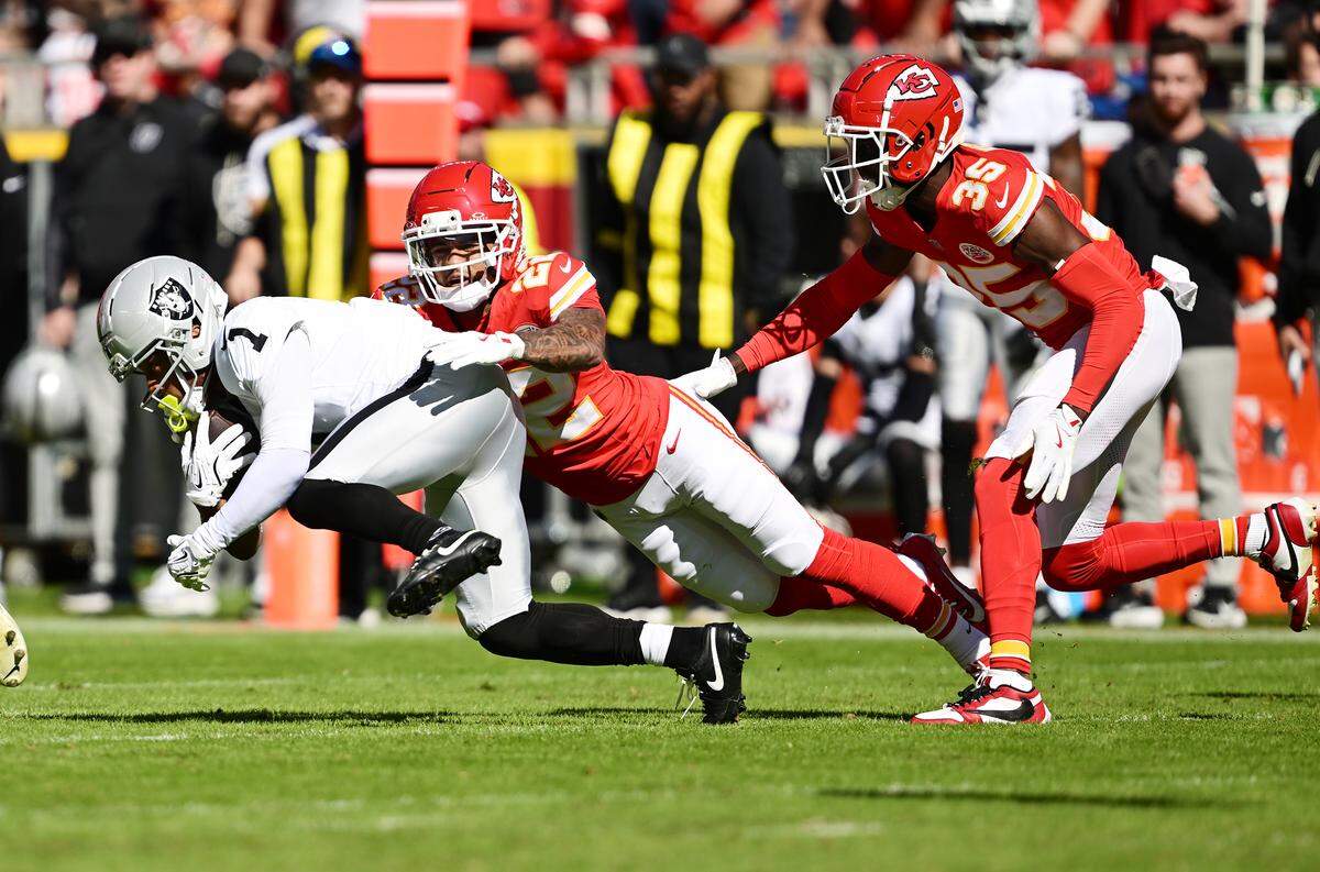 Chiefs cornerback Trent McDuffie brings down Las Vegas Raiders wide receiver Tre Tucker during an NFL Week 7 game at GEHA Field at Arrowhead Stadium in Kansas City on Sunday, Oct. 19, 2025.