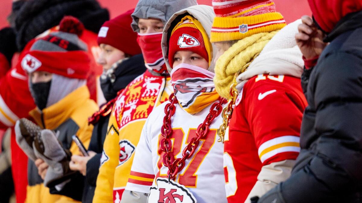 Chiefs fans stand behind the team’s bench before Saturday night’s AFC Wild Card playoff game against the Miami Dolphins at GEHA Field at Arrowhead Stadium.