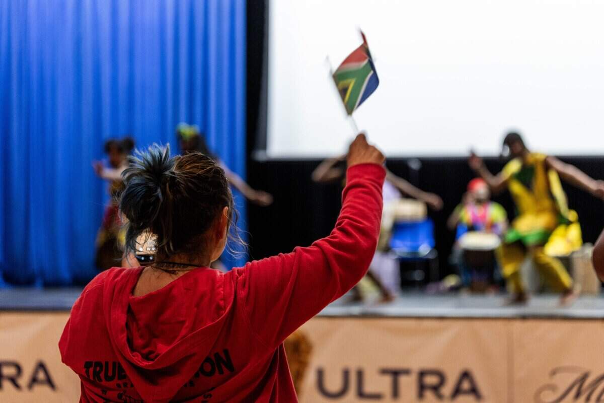 Lisa Aquino waves their flag as they cheer on the performers at the KCK Mexico v. South Africa Watch Party hosts at Memorial Hall on Thursday, June 11, 2026.