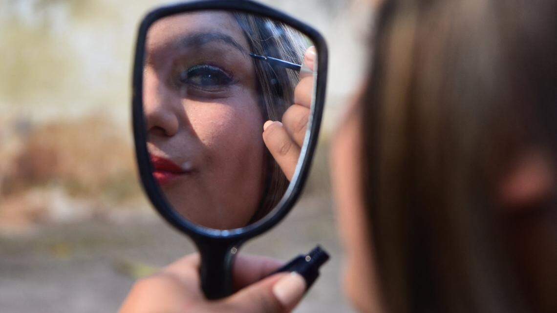 Woman putting on makeup.