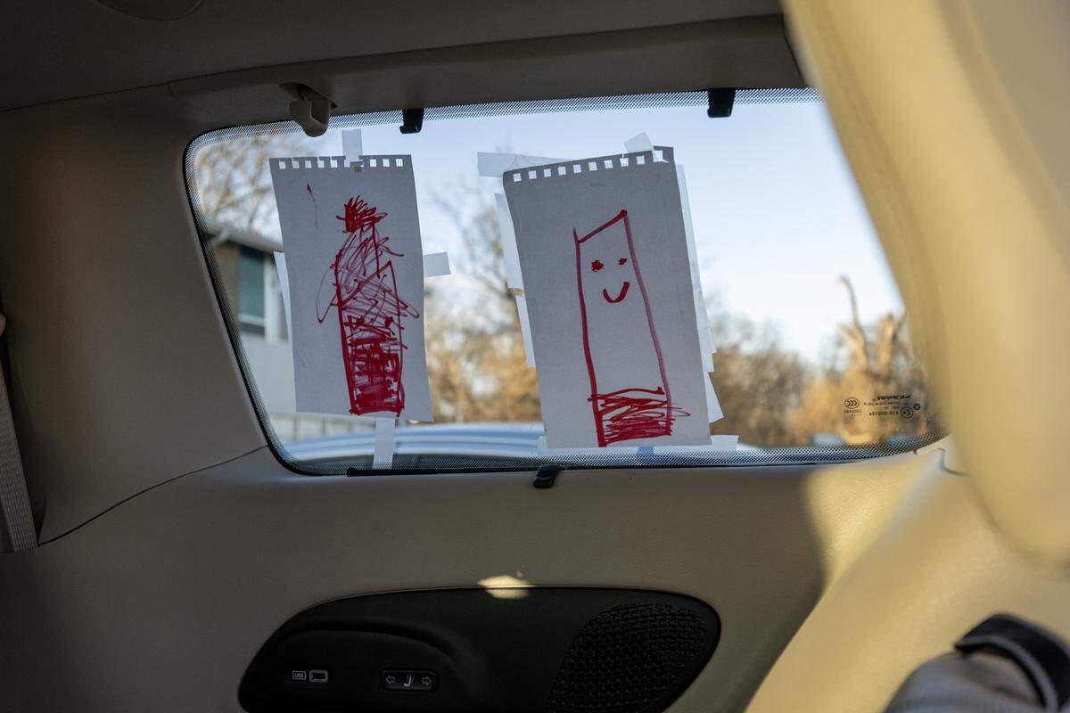 Children's drawings taped to a window are seen inside the van of Meaghan Fanning, director of youth services and counseling at the Jewish Vocational Office, on Tuesday, Dec. 16, 2025, in Kansas City.