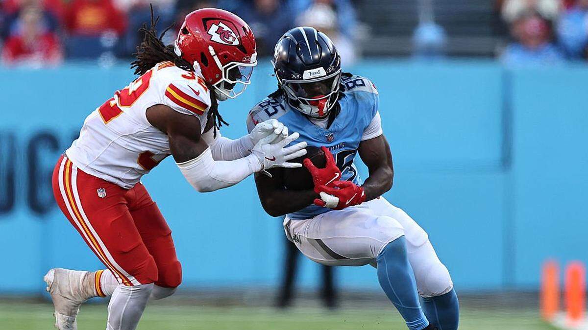 NASHVILLE, TENNESSEE - DECEMBER 21: Chig Okonkwo #85 of the Tennessee Titans is Nick Bolton #32 of the Kansas City Chiefs tackled by in the fourth quarter of the game at Nissan Stadium on December 21, 2025 in Nashville, Tennessee. (Photo by Justin Ford/Getty Images)