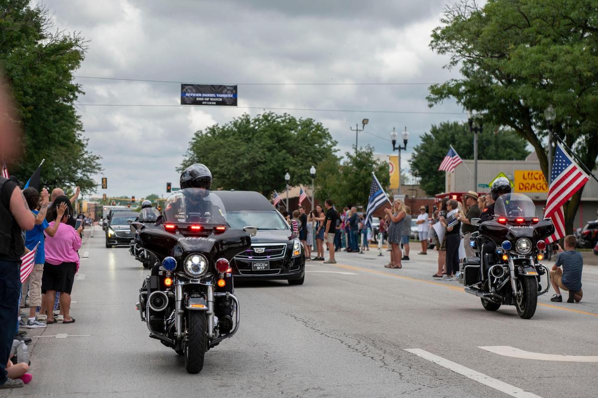 The funeral procession for North Kansas City police officer Daniel Vasquez drove down Armour Road, on Wednesday, July 27, 2022, in North Kansas City. Vasquez was fatally shot last week while pulling over a car with expired tags in North Kansas City.