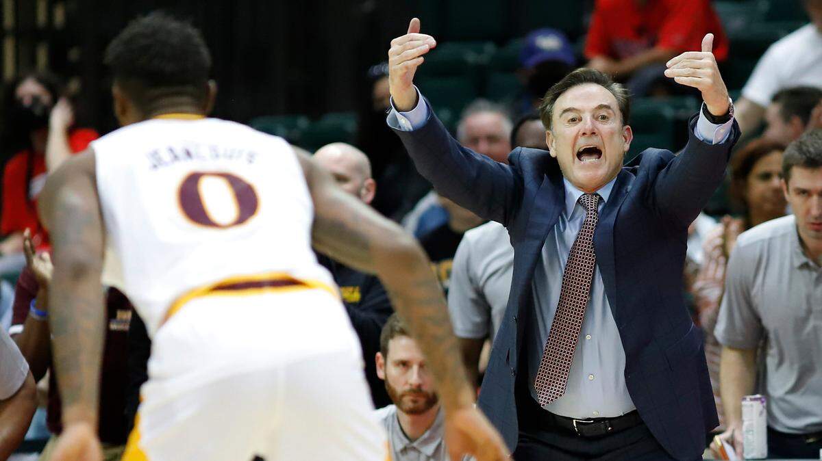 Iona guard Berrick Jeanlouis, left, guards an Alabama defender as Iona head coach Rick Pitino, right, yells to his team during the second half of Iona’s win over Alabama on Thursday in the ESPN Events Invitational.