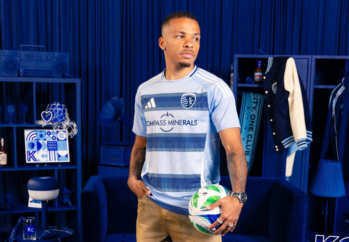Sporting Kansas City left-back Logan Ndenbe models the club’s new primary “One KC” kit for the 2025 Major League Soccer season.