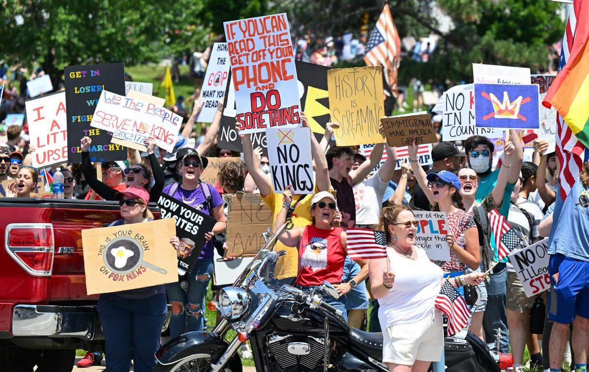 Protesters voice their dissent for the Trump administration during the “No Kings” rally Saturday, June 14, 2025, at Mill Creek Park in Kansas City.
