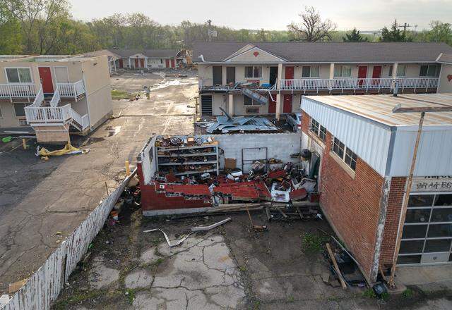 Damage was visible at the Knights Inn and McCurdy's Auto Service on Tuesday, April 14, 2026, in Ottawa, Kansas, after a tornado moved through the town Monday night.