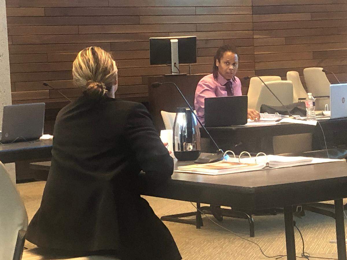 Kansas City police detective Tamara Solomon, right, represents herself at a disciplinary hearing in 2019 at department headquarters. At left, another police detective speaks about investigating Solomon’s domestic violence case.