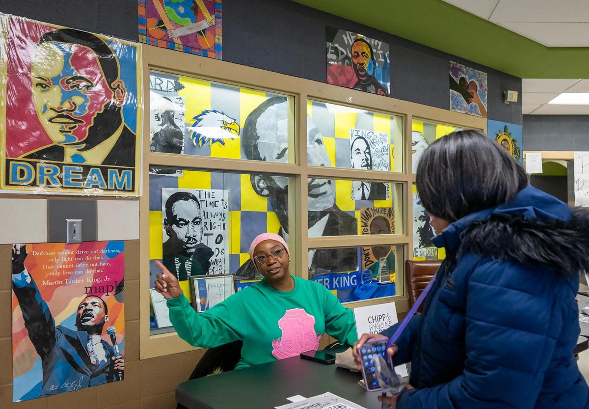 Gloria Wheaton, left, of Kansas City, directs a volunteer to the gym for the We Are ONE, Alpha Kappa Alpha Day of Service at Martin Luther King Jr. Elementary School on Monday, Jan. 20, 2025, in Kansas City. Over 140 members, graduate and undergraduate of the Kansas City Metro Chapters of the AKA sorority, gathered at the school to paint, pack hygiene kits, to provide financial literacy education, and pack food bags.