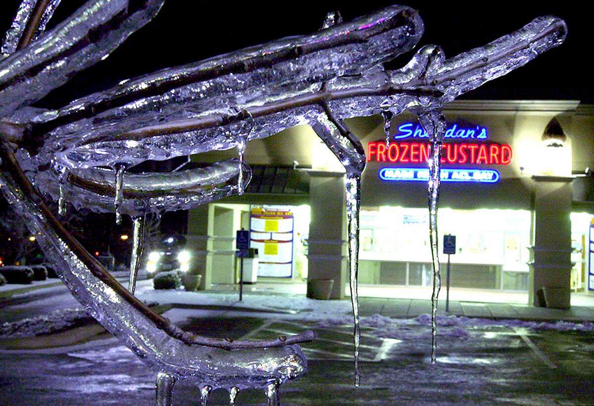 Icicles hang from a tree in the parking lot of Sheridan’s Frozen Custard store in Olathe in 2002,