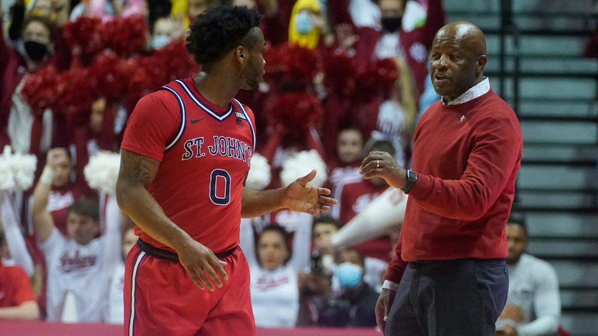St. John’s Posh Alexander (0) talks with head coach Mike Anderson during the second half of an NCAA college basketball game against the Indiana, Wednesday, Nov. 17, 2021, in Bloomington, Ind. Indiana won 76-74. (AP Photo/Darron Cummings)
