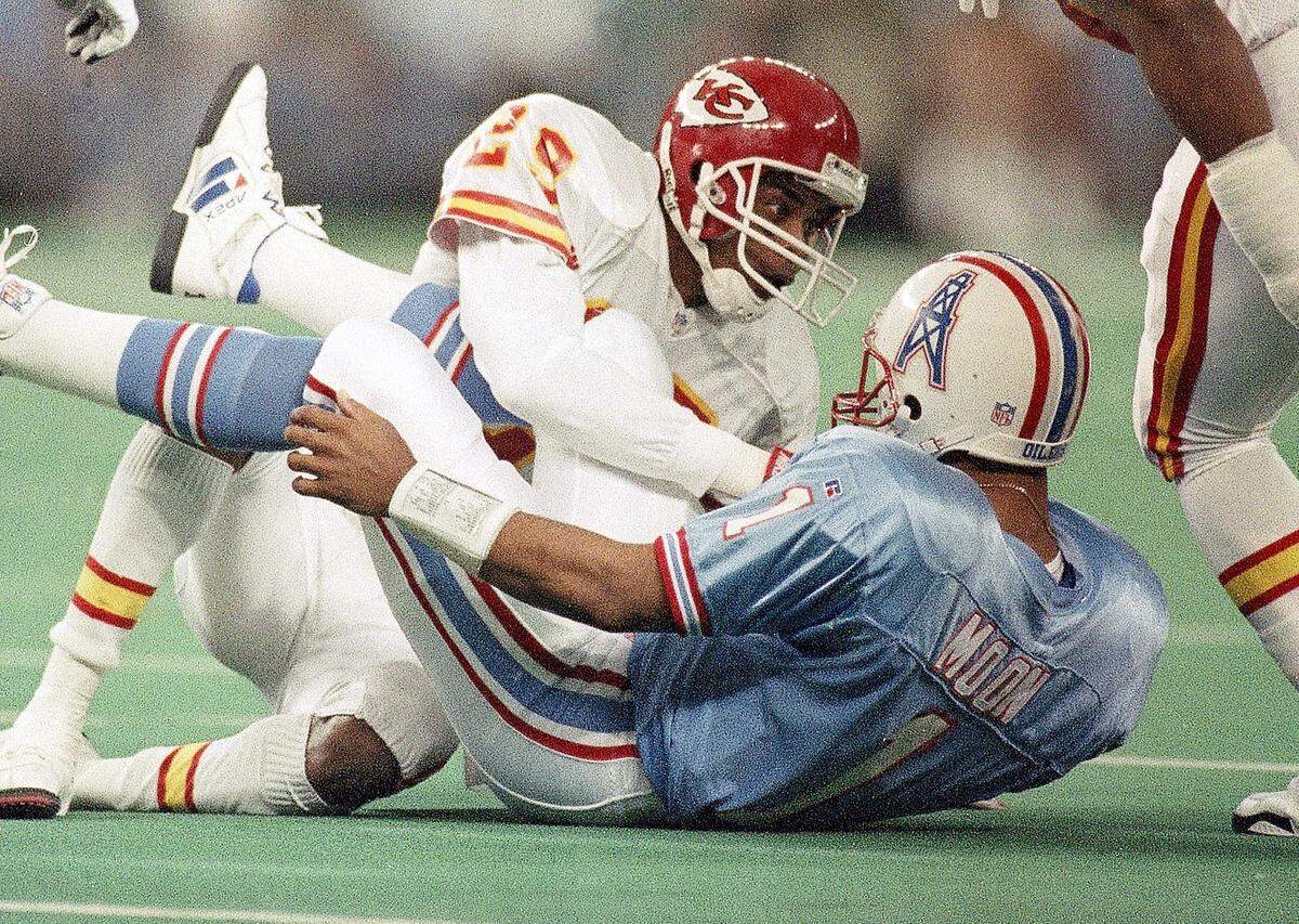 Chiefs defensive back Albert Lewis sacks Houston Oilers quarterback Warren Moon during a 1994 NFL playoff game.