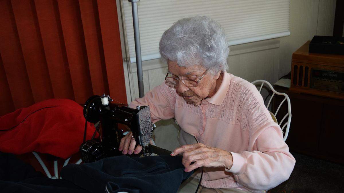 Stella Jobe, a volunteer at Lee’s Summit’s Hillcrest Thrift Store, does more than buy coats. She fixes them up before donating them to people in need..