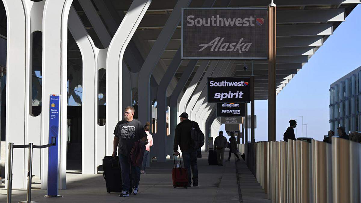 Travelers headed into the new $1.5 billion single terminal at Kansas City International Airport on opening day, Feb. 28, 2023.