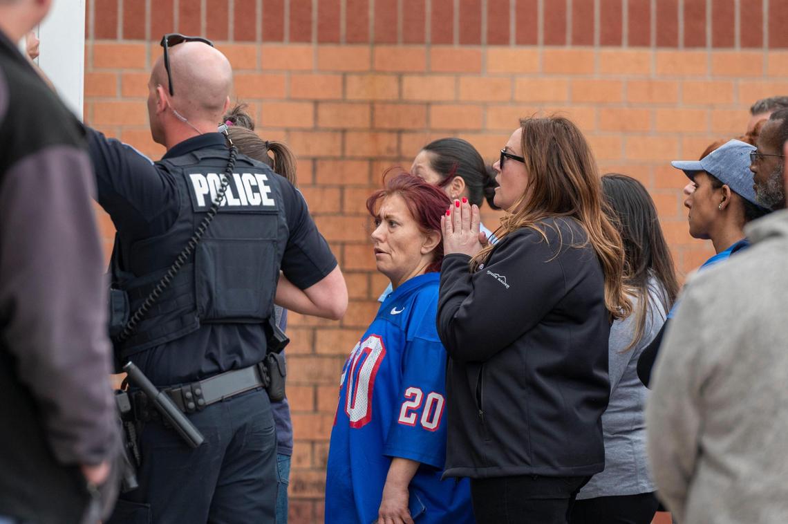 Parents wait outside California Trail Middle School to be reunited with their children on Friday, March 4, 2022. Parents were able to pick up their children at the middle school after reports of a shooting that occurred at Olathe East High School earlier that morning.