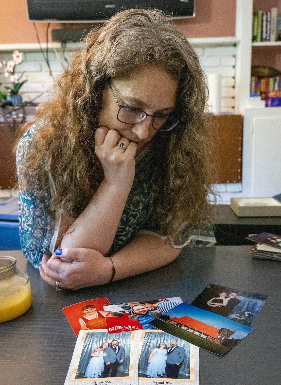 Laura Beth Mahoney looks over old family photos of her life and marriage to ex-husband Justin Meier at her home in Overland Park.