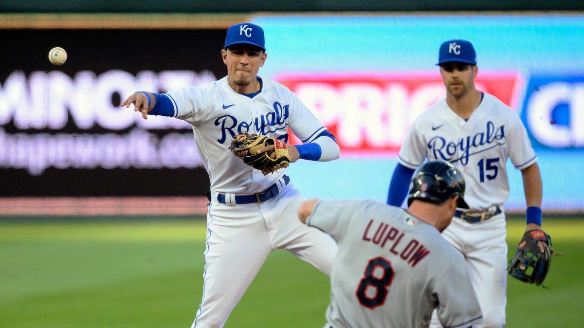 Kansas City Royals shortstop Nicky Lopez (8) throws over Cleveland Indians’ Jordan Luplow for a double play during the first inning of a baseball game Tuesday, May 4, 2021, in Kansas City, Mo. (AP Photo/Reed Hoffmann)