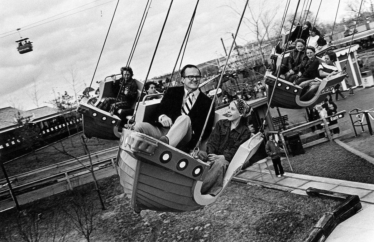 Lamar Hunt brought Worlds of Fun to Kansas City. On opening day in 1973, he took a spin on the Flying Dutchman with a girl who had waited in line with him.