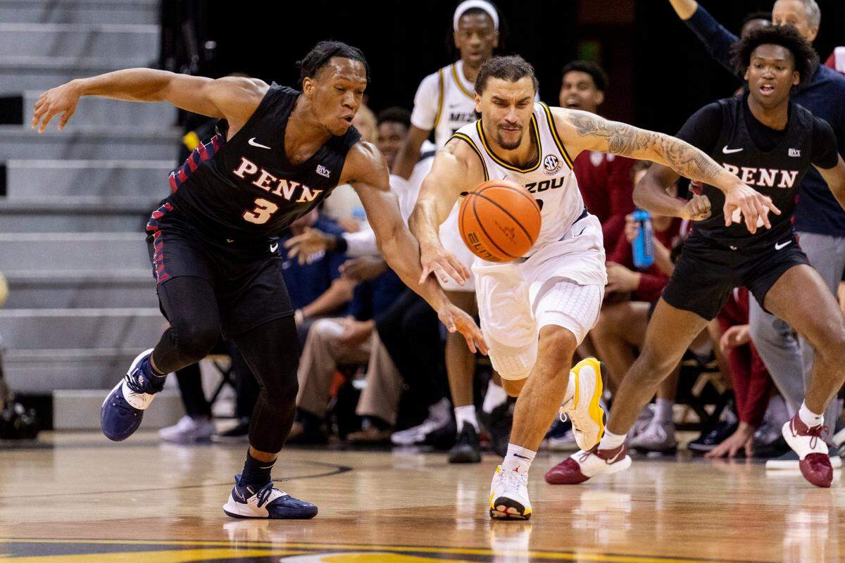 Missouri’s Tre Gomillion, right, and Penn’s Jordan Dingle, left, chase down a loose ball during a game in November 2022 at Mizzou Arena. Dingle entered his name into the NCAA transfer portal last week.